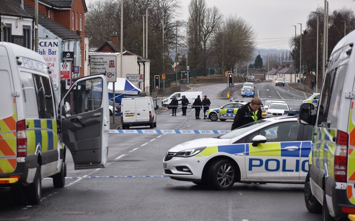 Police at the scene in Queens Cross, Dudley, where Mr Zeb was shot