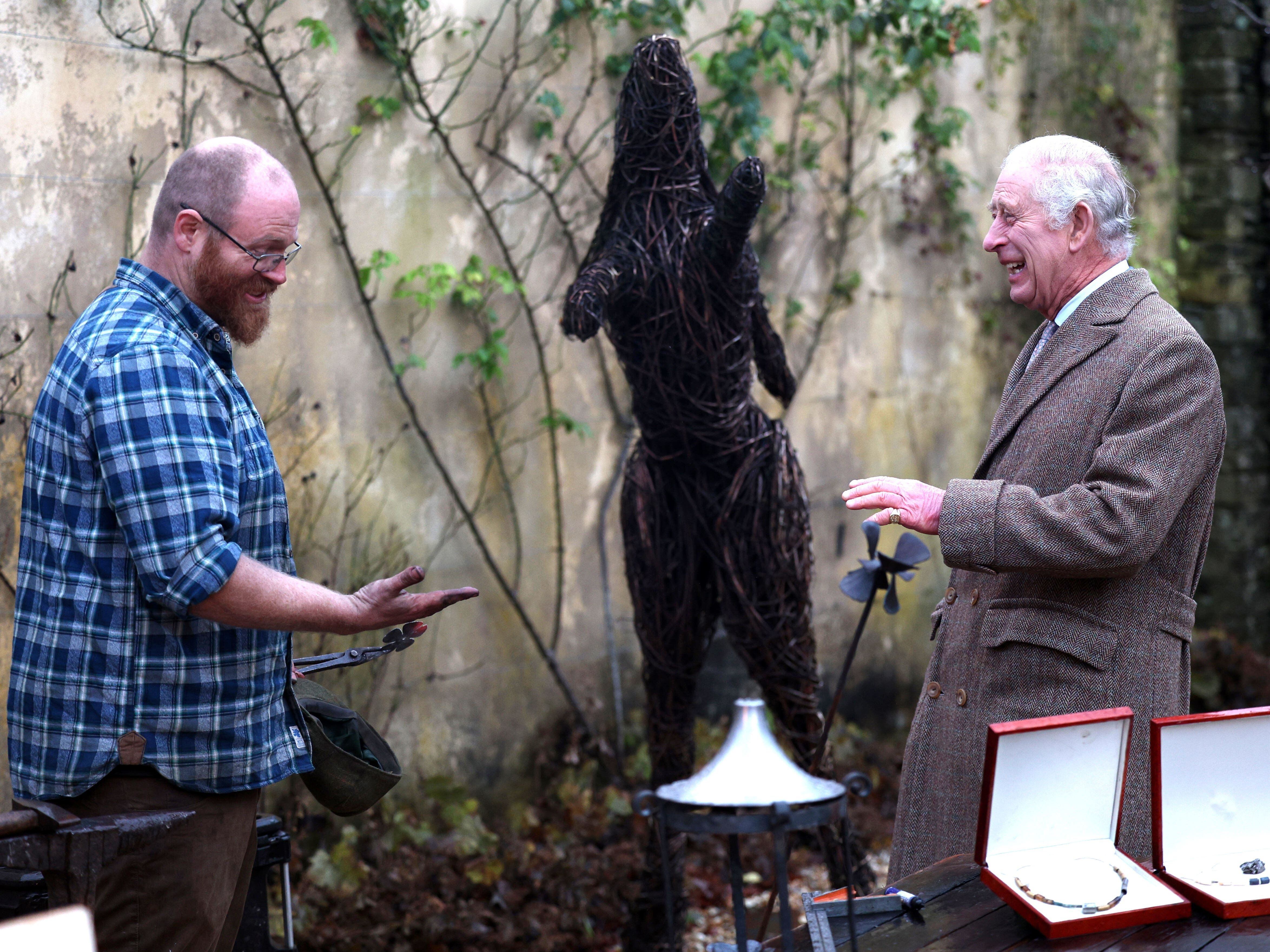 Hands off! Charles declines traditional greeting with dusty blacksmith