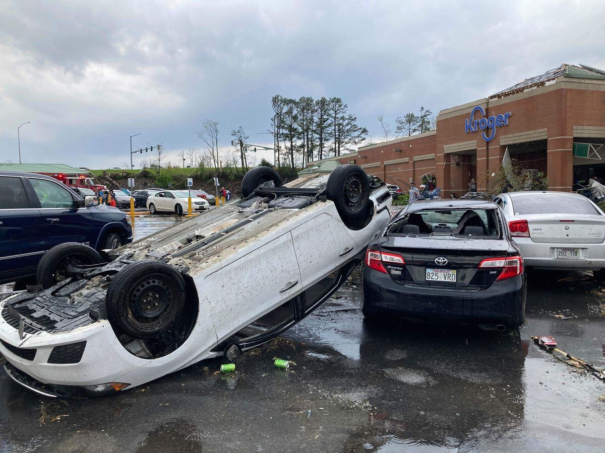 A car is upturned in a parking lot after the severe storm swept through Little Rock (Andrew DeMillo/AP)