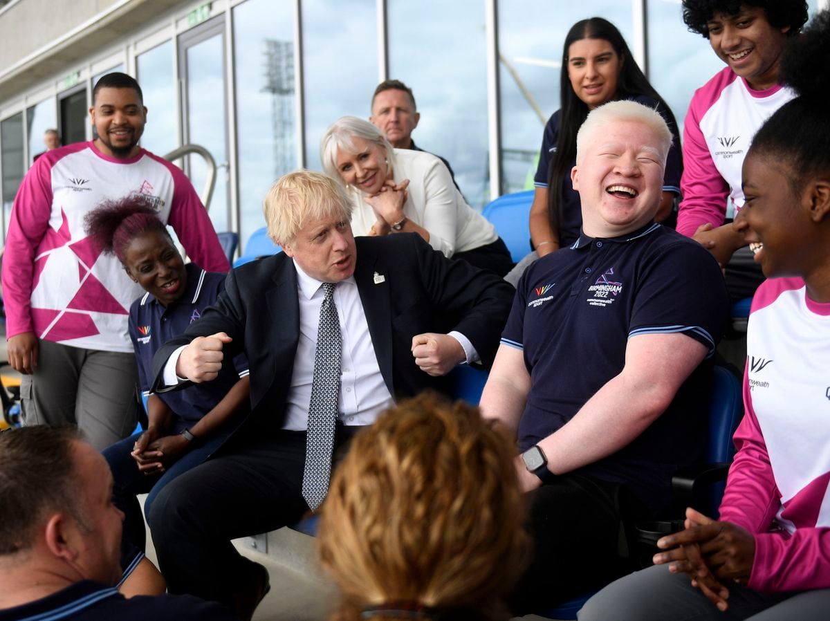 Boris Johnson and Culture Secretary Nadine Dorries meet baton bearers and volunteers during a visit to Alexander Stadium in Birmingham.