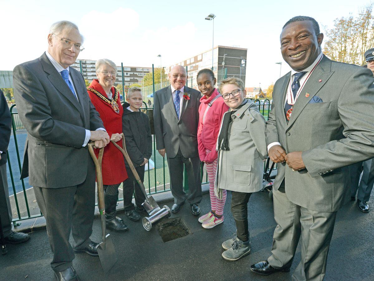 HRH The Duke of Gloucester, The Mayor of Wolverhampton, Councillor Claire Darke, Nicolas Janisz, Vic Collins, Christiana Izogie, Reece Brookes and Deputy Lieutenant of the West Midlands Martin Levermore as he buries a time capsule during his visit to The Hope Community Project at Ling House, Long Ley, Wolverhampton