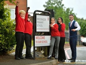 Headteacher Russell Bond is pictured with Riley Cooke, Musab Mohammed, Yasmin Spence, and Hanna Ahmed, all aged 11