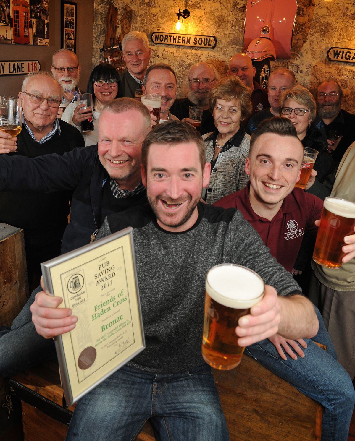 Celebrating a bronze award from CAMRA, (centre) manager Matt Carey, of Cradley Heath, with Friends of Haden Cross, including (front left) chairman Tim Haskey, of Cradley Heath, and members of Dudley & South Staffordshire CAMRA, including (front right) chairman Ryan Hunt, of Dudley, at The Haden Cross, Halesowen Road, Cradley Heath.