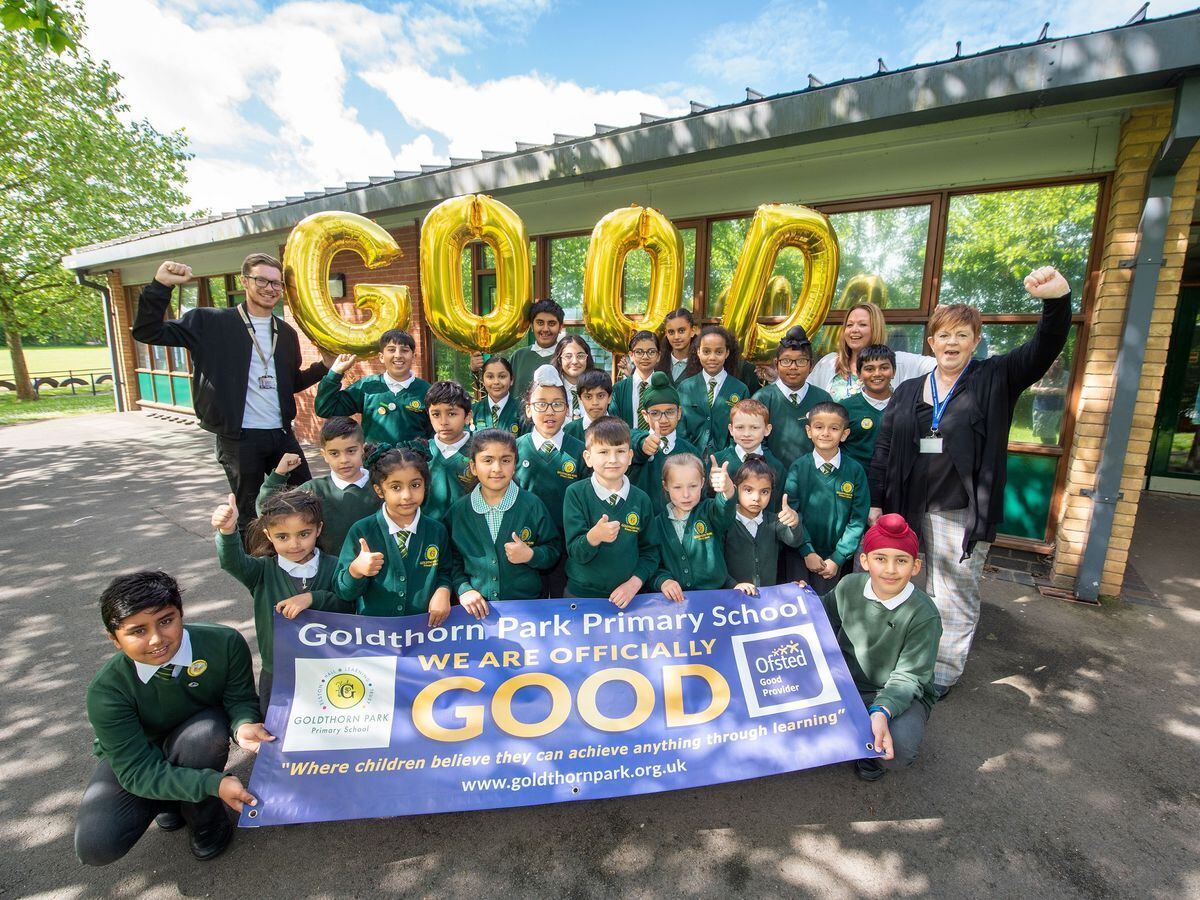Back row, left to right, Councillor Chris Burden, Cabinet Member for Education, Skills and Work, Rachel Purshouse, Deputy Headteacher, and Jo Hemmings, Headteacher, celebrate a Good Ofsted report with Goldthorn Park Primary School pupils.