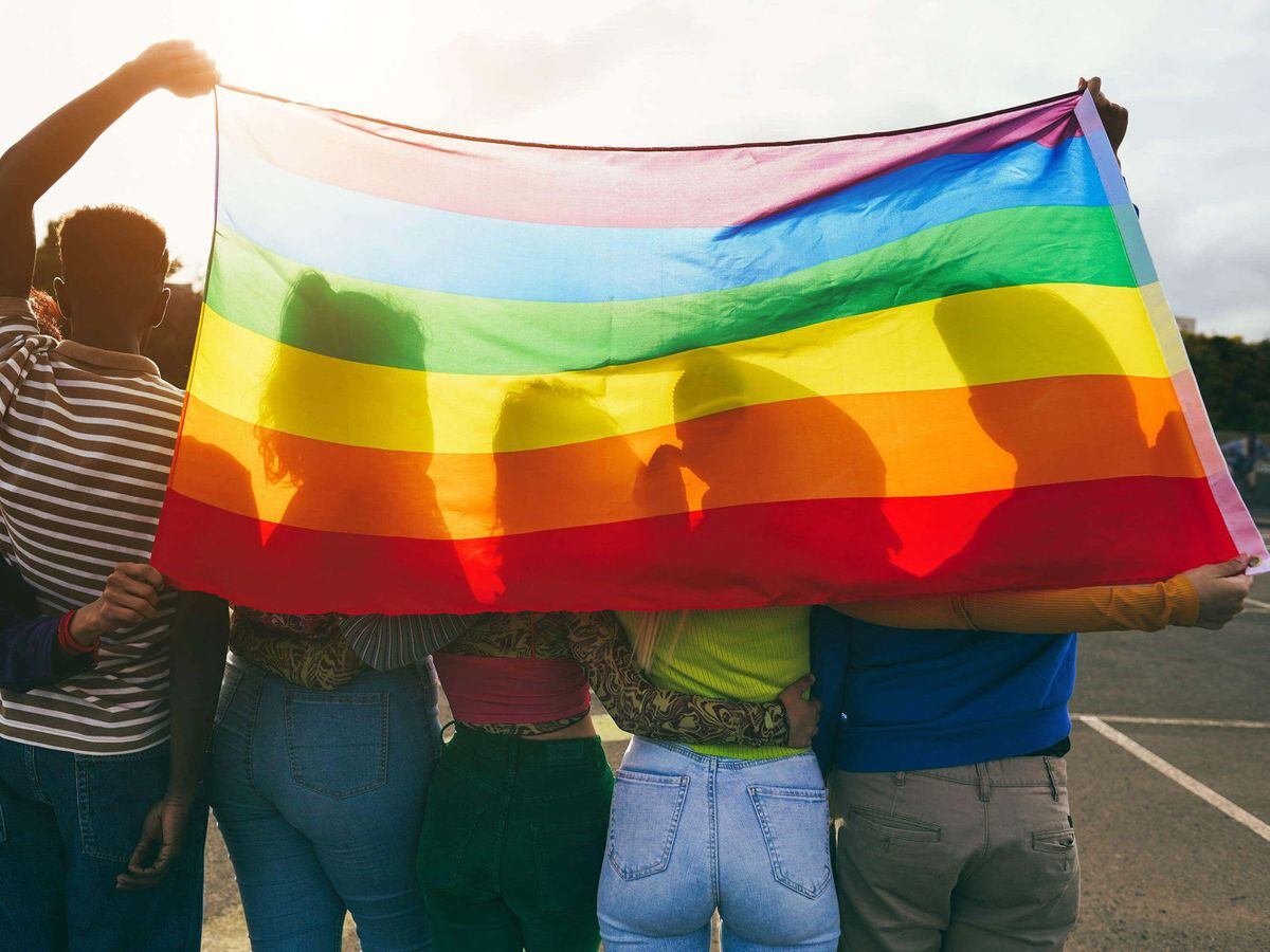 A group of teenagers with a rainbow