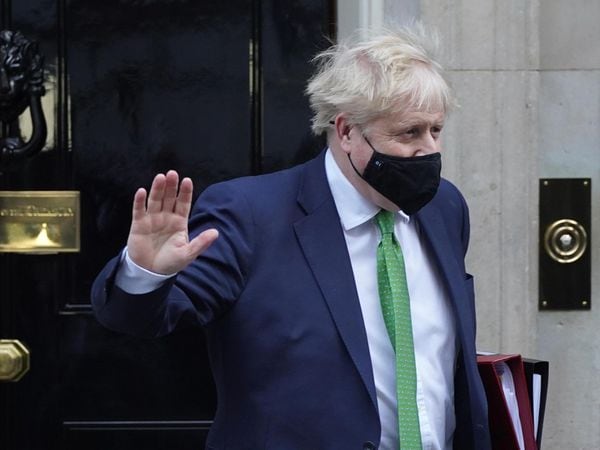 Prime Minister Boris Johnson waves while leaving Downing Street