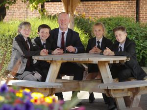 Headteacher Bryn Thomas with pupils from the school after their 'Good' rating.
