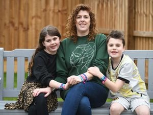 Becky Moorhouse with her children Oscar and Connie  wearing wristbands to mark World Cancer Day on February 4 in memory of the children’s dad Roger Moorhouse