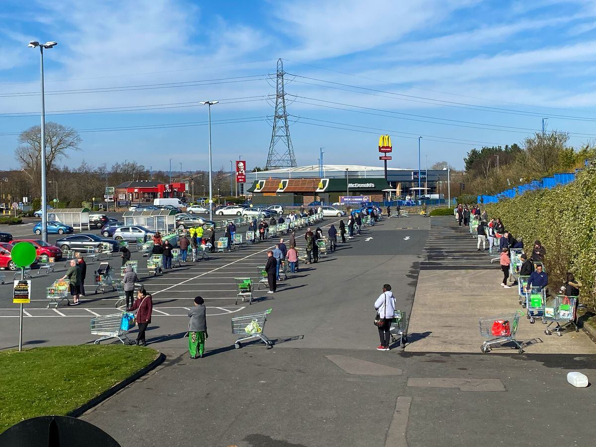 Scenes were much more controlled at Asda in Great Bridge were customers were told to queue 2m apart in the car park. Image: John Kennett