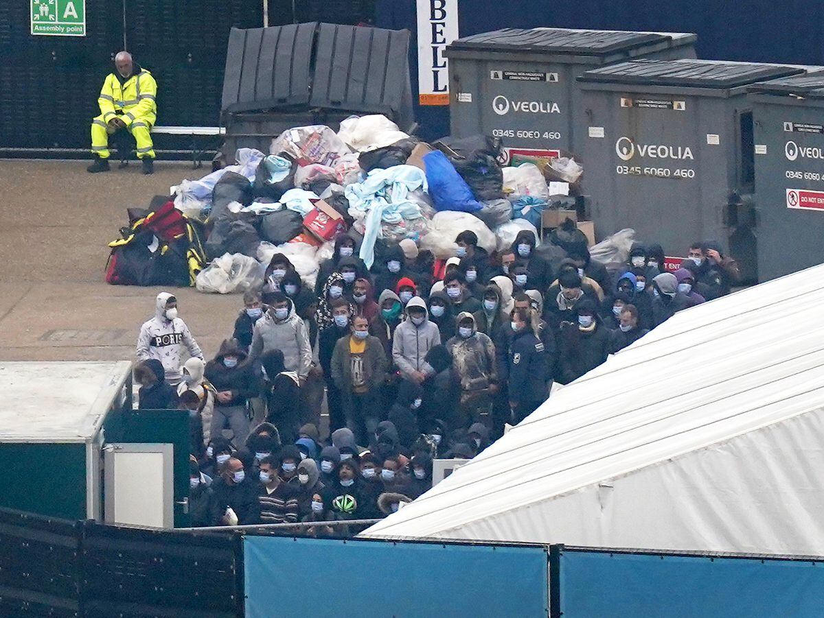 Migrants wait to be processed after being brought in to Dover, Kent, by a Border Force vessel on November 4. Photo: Gareth Fuller/PA Wire