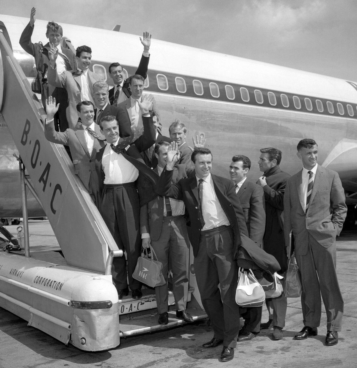 Their hopes soaring, England's World Cup footballers wave before leaving London Airport this morning (Thursday) for Chile and the World Cup series. They are due to return to this country in late June...From top: Gerry Hitchins, Stan Anderson, Johnny Haynes, Ron Flowers (left), Jimmy Greaves (right), Bobby Robson, Peter Swan, Ron Springett (face hidden), Bobby Charlton, Ray Wilson (face hidden), Jimmy Armfield, John Connolly, Alan Peacock and Bobby Smith..