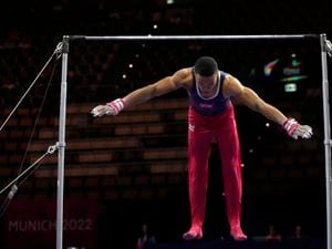 England's Joe Fraser performs during the Men's All-Around Final at the European Gymnastics Championships in Munich, Germany, Thursday, Aug. 18, 2022. (AP Photo/Pavel Golovkin).