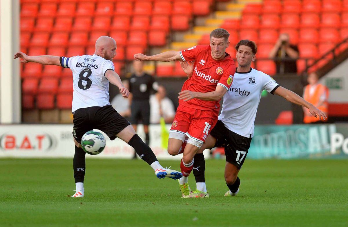 Walsall's Tom Knowles up against Swindon Town's Ricky Aguiar