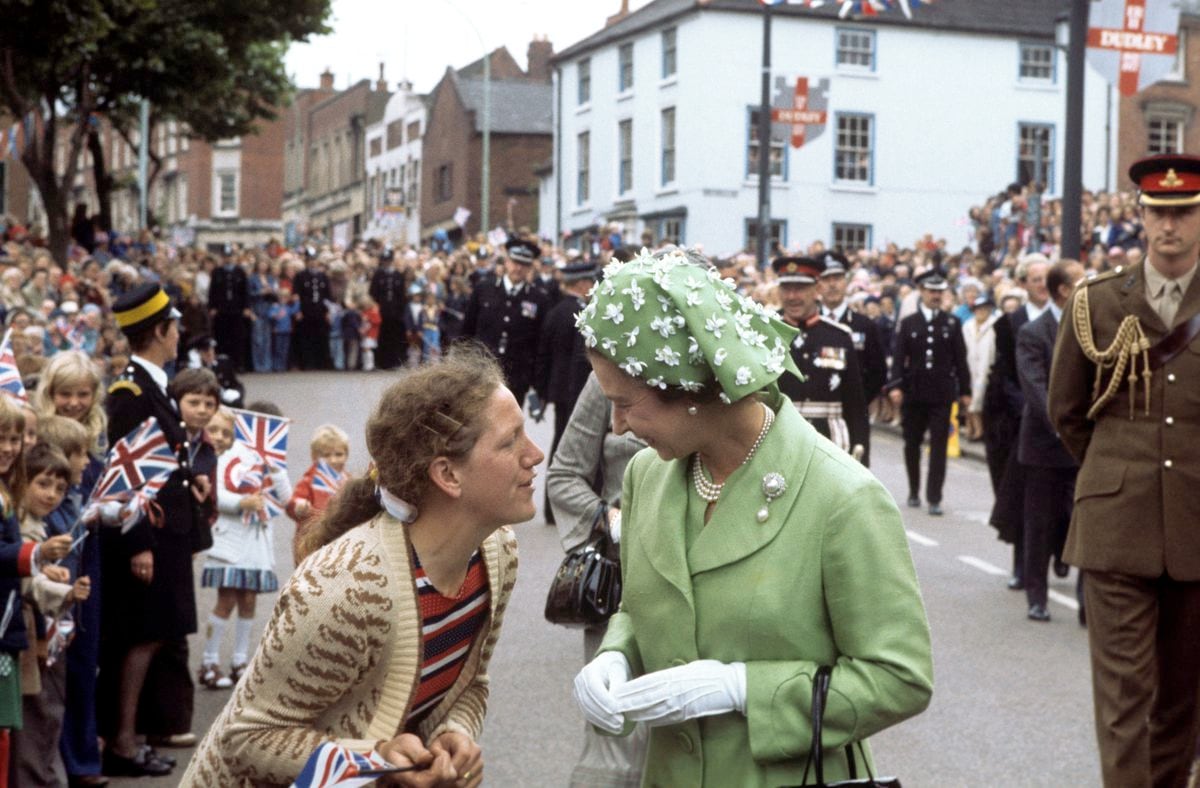 Queen Elizabeth II has a chat whilst on a walkabout in Dudley, during her Silver Jubilee Tour of Britain