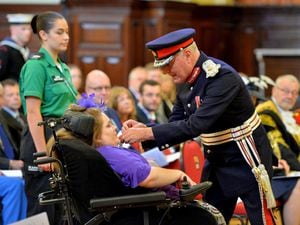 Ceri receives her British Empire Medal from Lord Lieutenant John Crabtree OBE