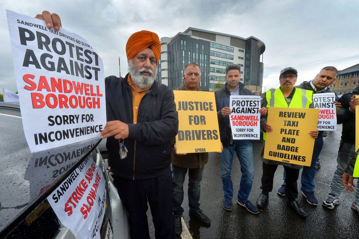 Jaswinder Dhesi and drivers show off some of their messages to the council