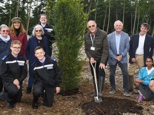 L to R: 'Terry Wood planting the Yew Tree with Sutton Coldfield Charitable Trust Chair of Trustees, Chief Executive, almshouse residents, Little Sutton Primary School children, West Midlands Police Cadets at Manorial Wood for the Queen’s Jubilee Canopy Initiative in Sutton Coldfield.' 
