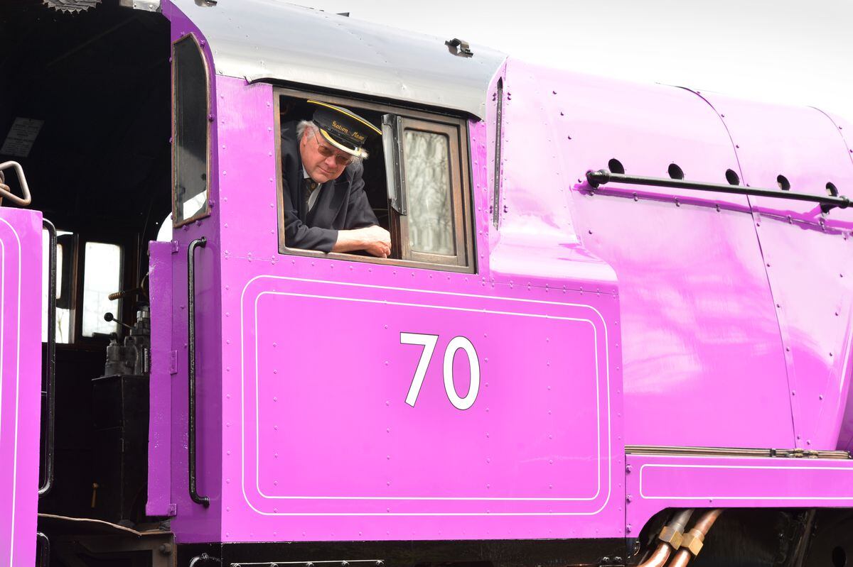 Station master Chris Thomas shows off the train's new purple livery
