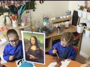 Children Ivy Walker and Edith Willies concentrate on getting da Vinci's brush strokes correct