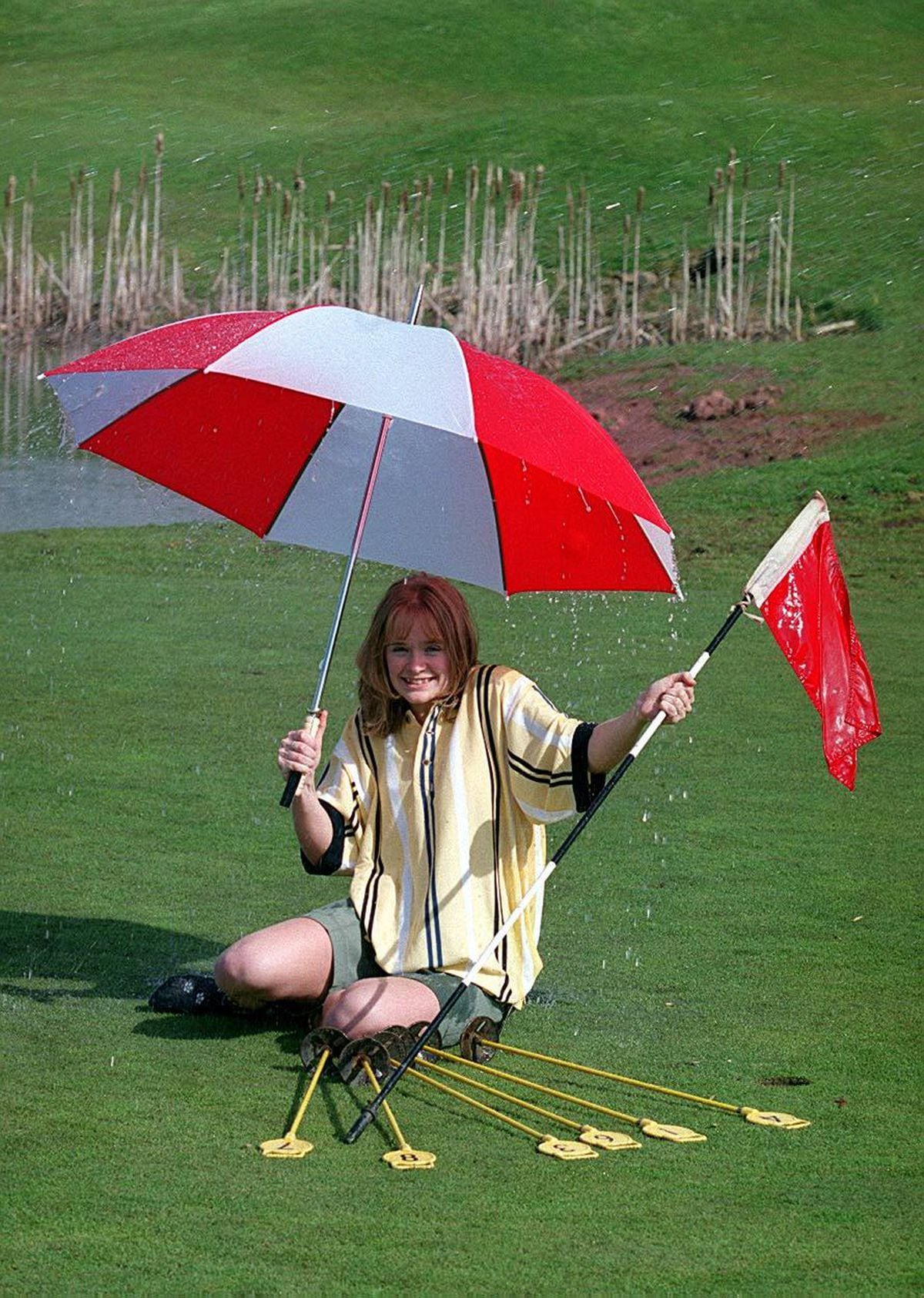 Trainee manager Claire Wall, then 18, under the sprinklers on the putting green at The Shropshire Golf complex at Muxton