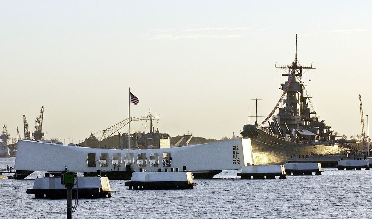 The USS Arizona Memorial, left, sits astride the sunken wreck of the battleship. In the background at this 60th anniversary event is the battleship USS Missouri, on which the Japanese surrender was signed in 1945.
