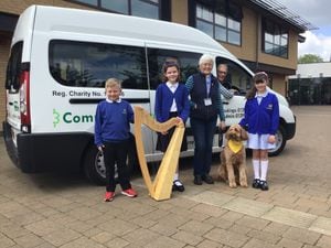 Sue Beeson and Boo with volunteer driver Jon Crellin and pupils at Catherine’s CE Primary School