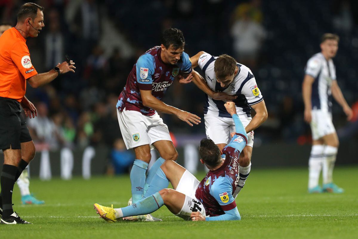 Connor Roberts of Burnley strikes out at Jayson Molumby of West Bromwich Albion during the Sky Bet Championship between West Bromwich Albion and Burnley at The Hawthorns on September 3, 2022 in West Bromwich, United Kingdom. (Photo by Adam Fradgley/West Bromwich Albion FC via Getty Images).