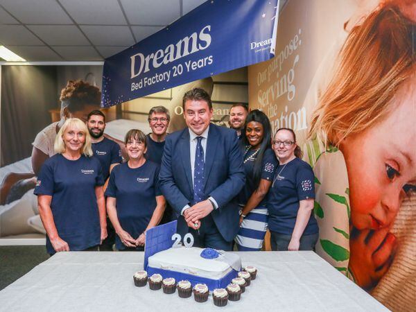 MP Shaun Bailey cutting the cake with Dreams employees