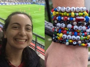 Andrea Scott/World Cup-themed bracelets stacked on her arm