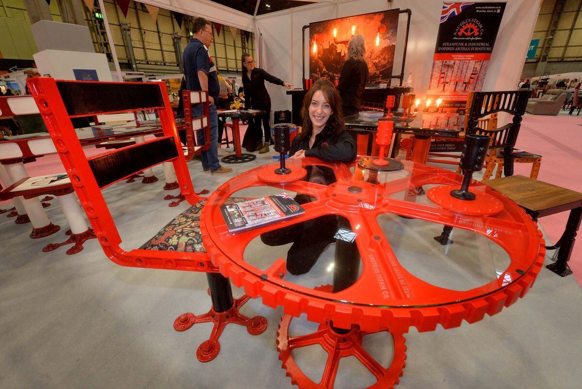 Nicole Douglas from Nautilus Steam Co shows of an industrial-themed dining table at Grand Designs Live