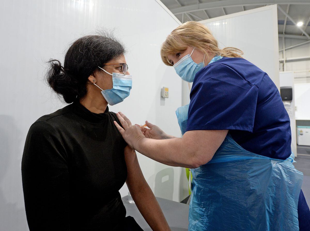 SANDWELL COPYRIGHT EXPRESS&STAR TIM THURSFIELD 03/03/21.Tipton Sports Academy becomes a covid vaccination centre..Indu Dhanjal-Nanra from Wolverhampton is given the jab..