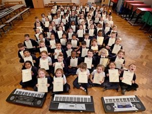 Pupils at St Joseph’s Catholic Primary School in Darlaston celebrate after receiving their certificates of distinction