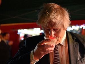 Boris Johnson samples gin during a visit to a market