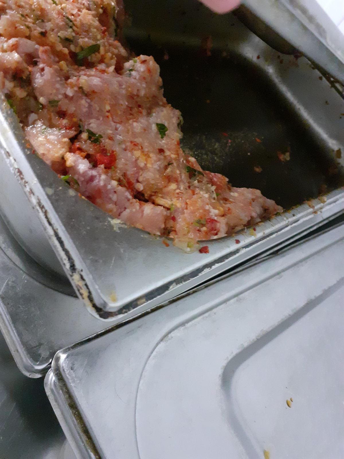 Seasoned/flavoured raw meat in a container at the restaurant