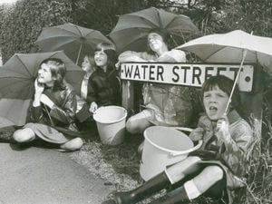 Young residents of Water Street, Chase Terrace, look hopefully for rain in 1976