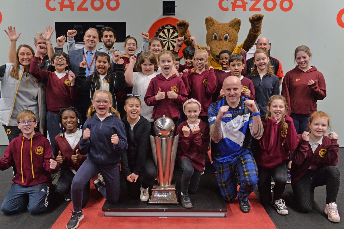 The participants from the event get the chance to pose with the World Championship trophy on the stage at Aldersley Leisure Village