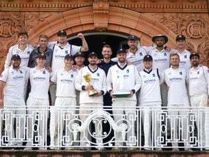               Warwickshire pose on the dressing room balcony with the Bob Willis Trophy and the County Championship Trophy after day four of the Bob Willis Trophy Final at Lord's, London