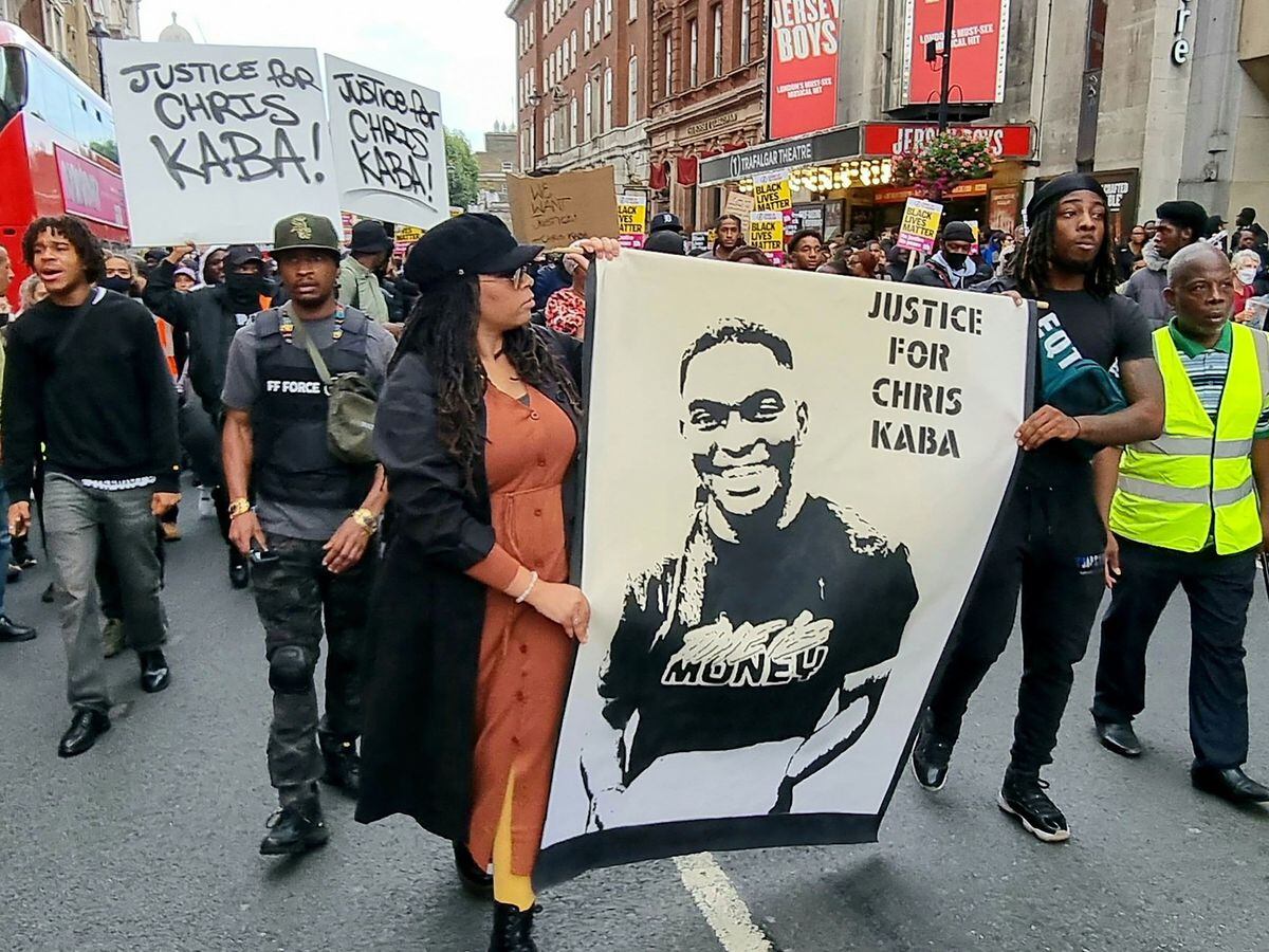 Campaigners hold a 'Justice for Chris Kaba' poster