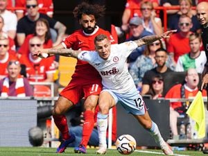 Liverpool's Mohamed Salah and Aston Villa's Lucas Digne battle for the ball 