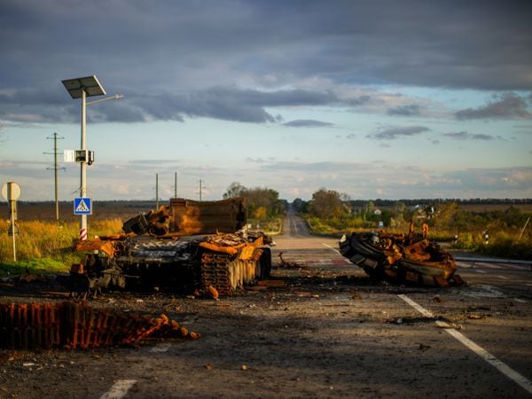 Remains of a destroyed Russian tank are scattered on the ground along the road between Izium and Kharkiv, Ukraine