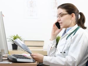 A generic stock photo of a female doctor looking at test results.