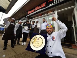 Awlad Hussain (front) celebrates winning the British Bengal Curry Awards 2022 Chef of The Year and Takeaway of The Year with staff members