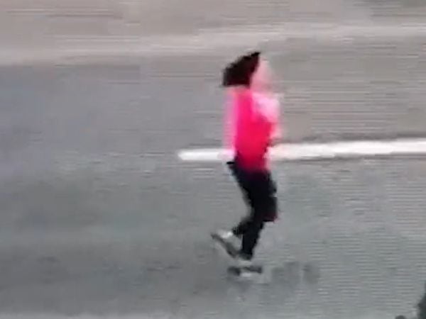The woman was seen running along the road after parking her car. Photo: West Midlands Police