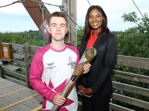 Batonbearer Oliver Turrell and Denise Lewis hold the Queen's Baton during the Birmingham 2022 Queen's Baton Relay at a visit to The Eden Project in Cornwall. (Photo by Nick England/Getty Images for Birmingham 2022 Queen's Baton Relay)