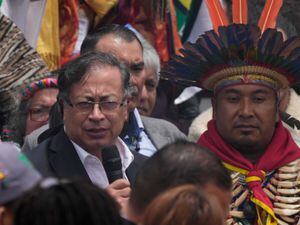 President-elect Gustavo Petro, left, speaks to supporters during a "popular and spiritual" inauguration ceremony presided over by local Indigenous groups and feminist activists (Ariana Cubillos/AP)