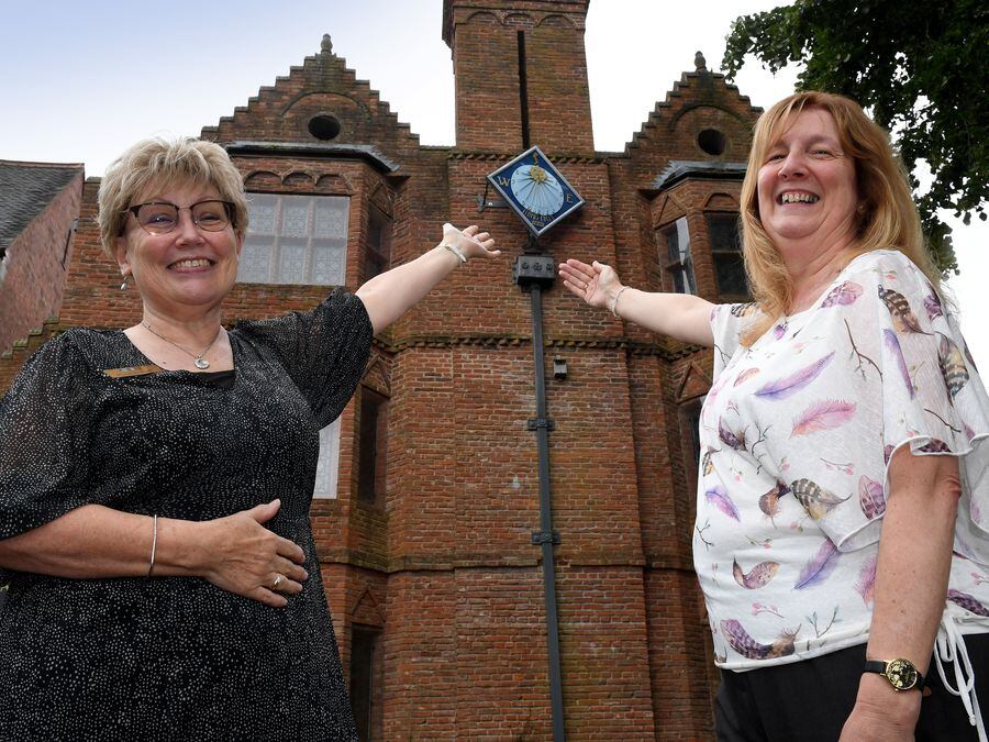 Staff members Anne Willetts and Alison Hyatt show off the new sundial