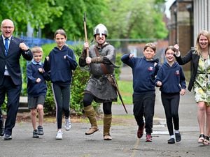 STAFFORD COPYRIGHT MNA MEDIA TIM THURSFIELD 19/05/22.Viking 'Ragnar the Bold' along with County Councillor David Williams and co-headteacher Jacqui Brian promote Walk to School week with pupils from Tillington Manor Primary School, Stafford..