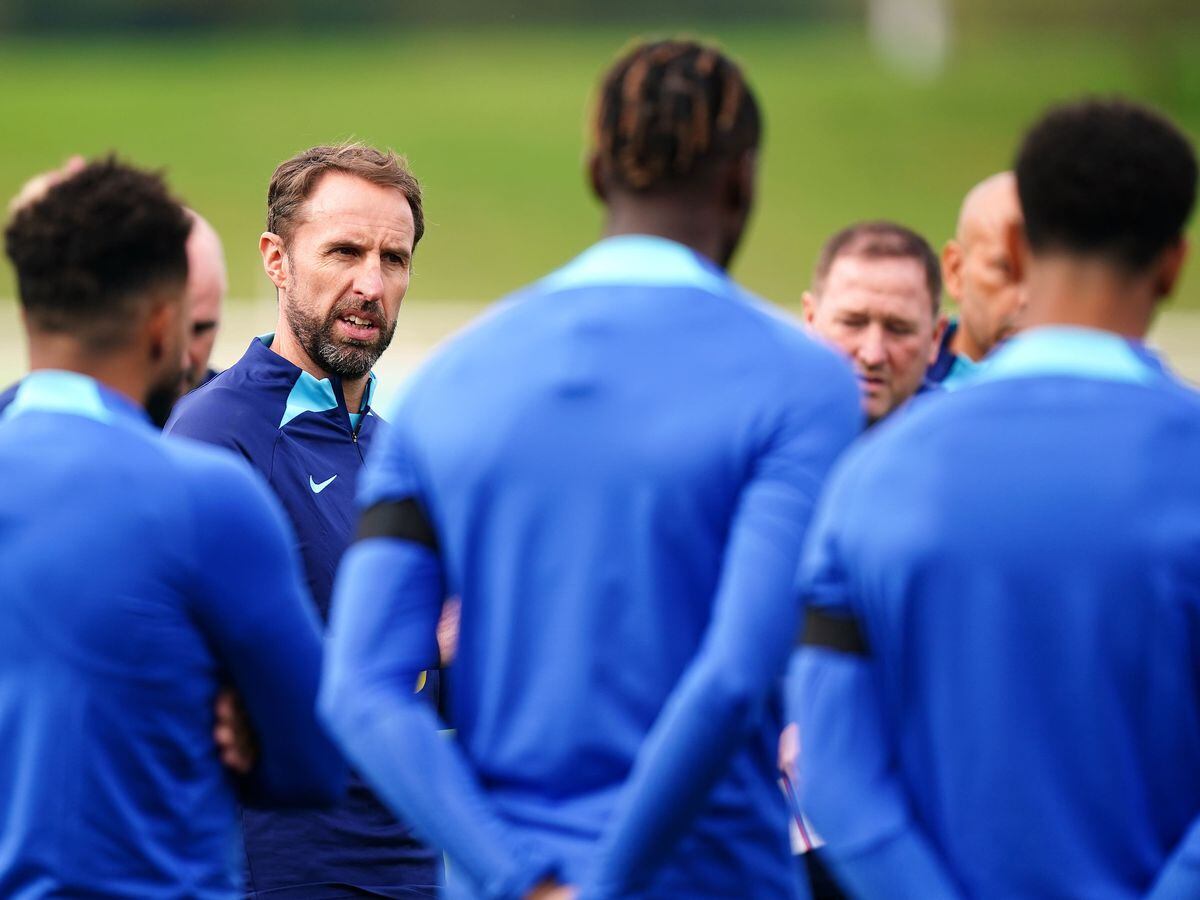 Gareth Southgate, centre left, speaks to his England squad in training