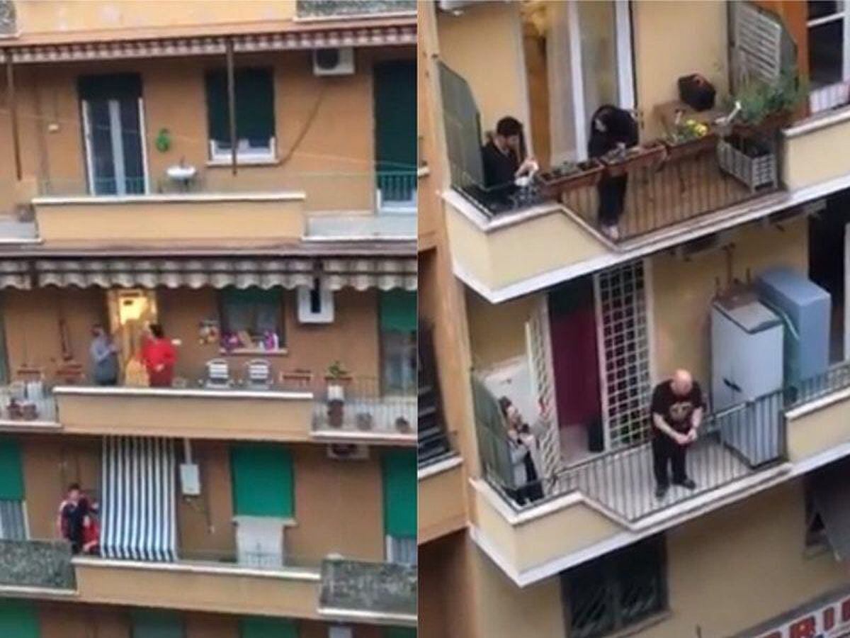 People gather on their balconies in Rome to sing the national anthem during the coronavirus lockdown