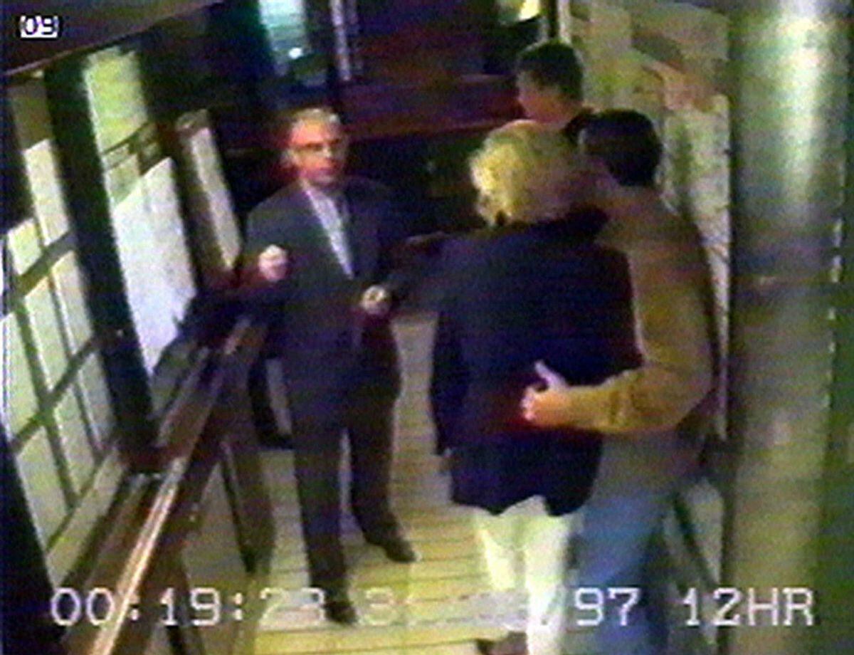 Dodi Fayed, right, puts his arm around Diana, Princess of Wales, as they prepared to leave the Ritz Hotel in Paris. They are seen talking to Henri Paul, with former Shropshire paratrooper Trevor Rees-Jones in the background. 